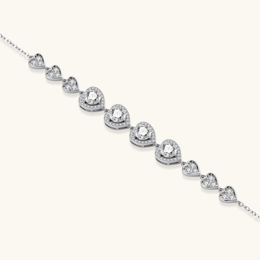 Complete jewelry set with heart-shaped sterling silver pieces featuring brilliant moissanite stones on white background.