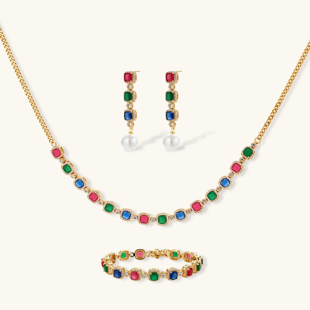 Gold-plated jewelry set with red, green, and blue cubic zirconia stones including necklace, bracelet, and drop earrings.