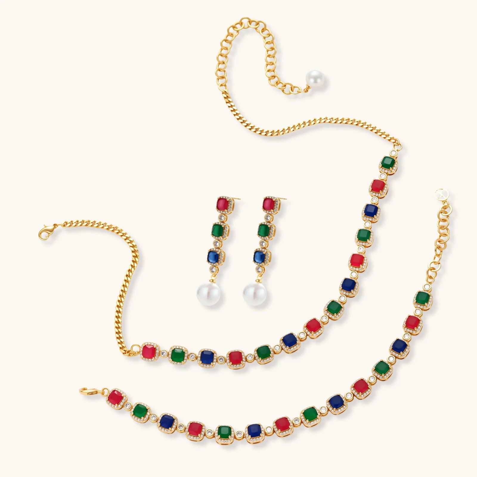 Gold-plated jewelry set with red, green, and blue cubic zirconia stones including necklace, bracelet, and drop earrings.