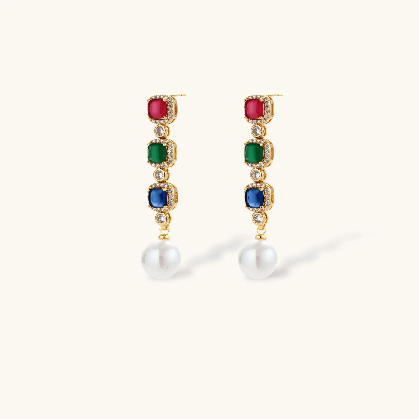 Gold-plated jewelry set with red, green, and blue cubic zirconia stones including necklace, bracelet, and drop earrings.