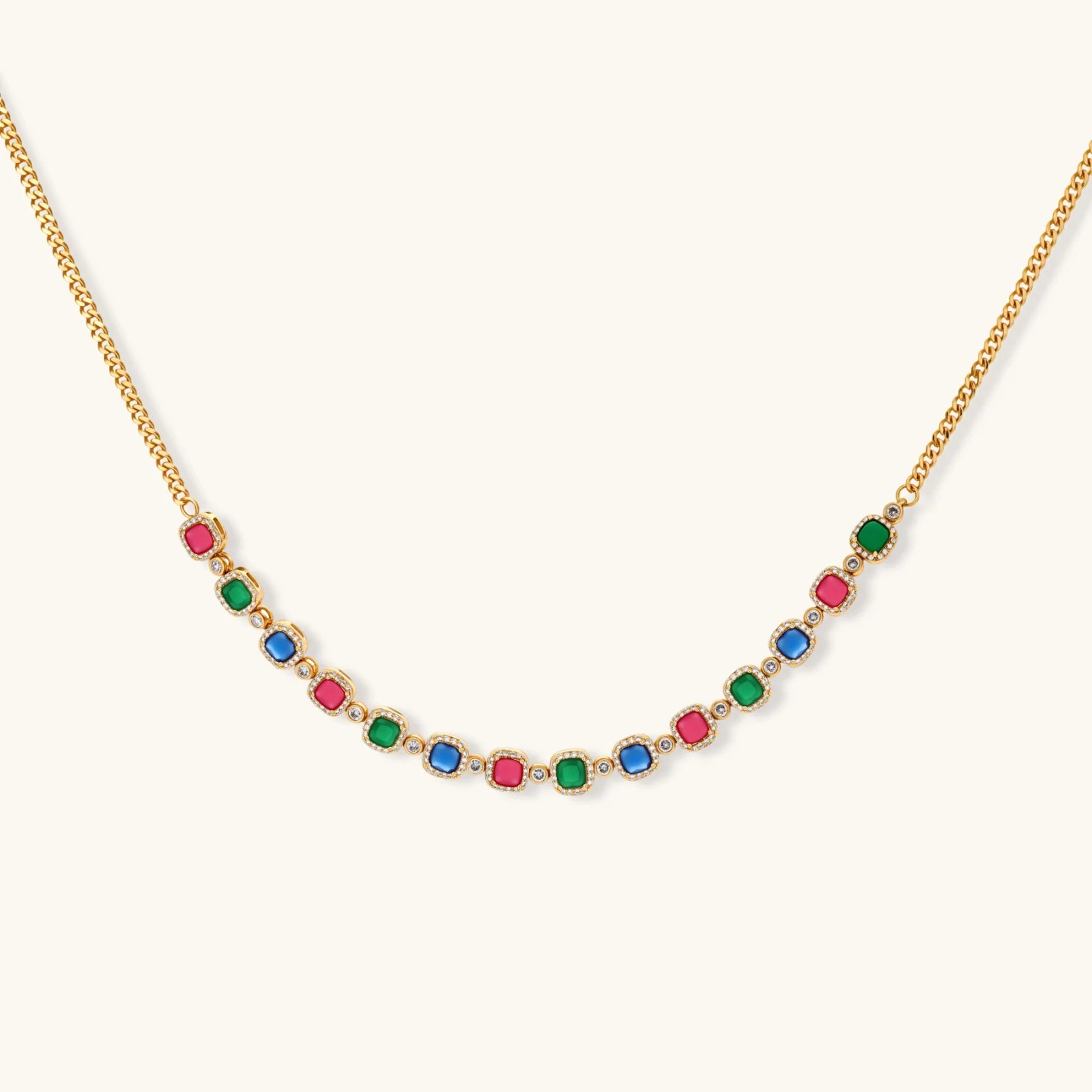 Gold-plated jewelry set with red, green, and blue cubic zirconia stones including necklace, bracelet, and drop earrings.