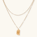 Layered paperclip chain necklace with organic flowing pendant made from eco-zinc alloy in warm gold finish