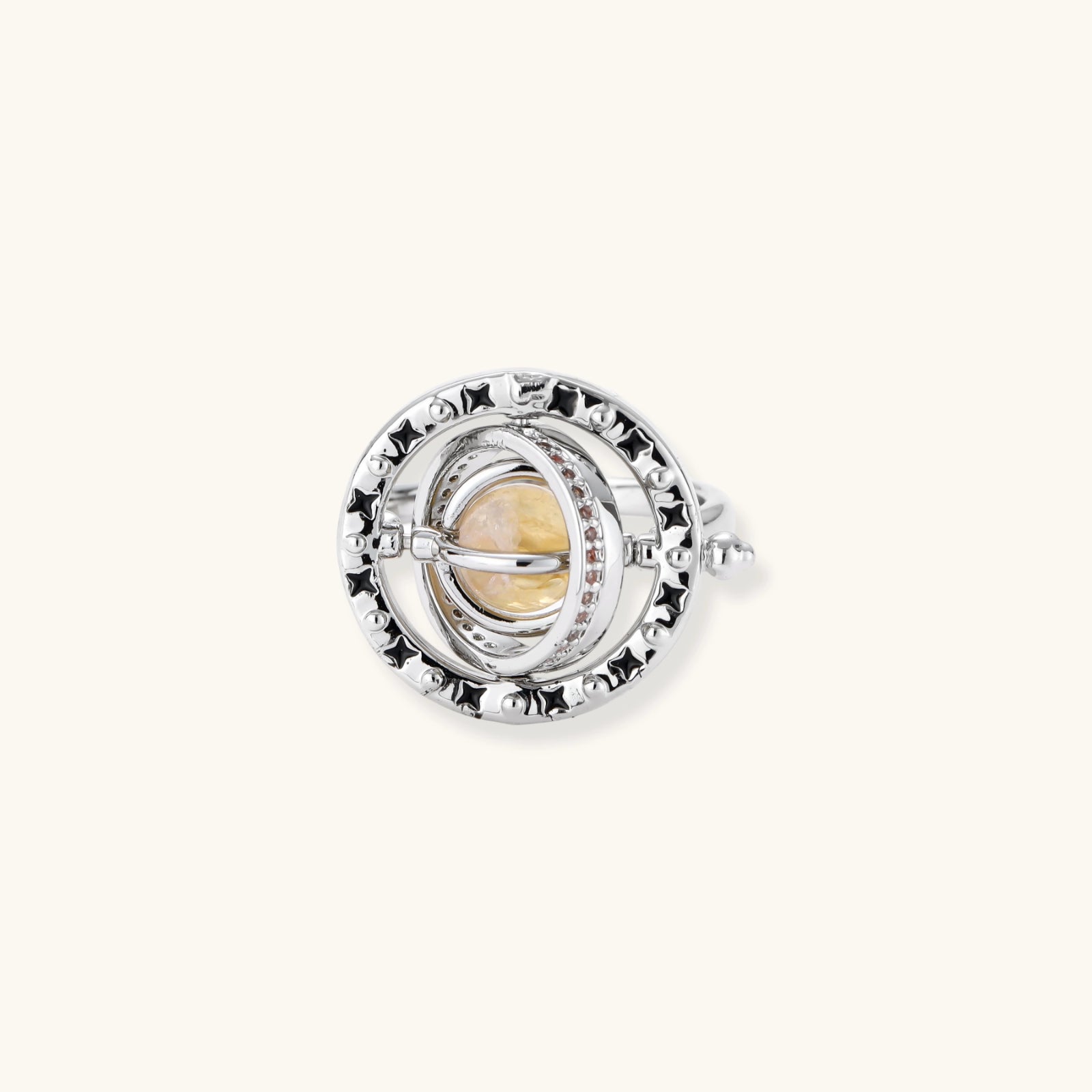 Adjustable brass ring with rotating zirconia center, surrounded by black enamel celestial stars and moon details