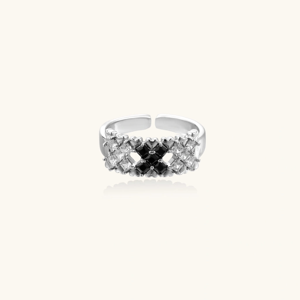Adjustable white gold plated ring with geometric grid of black and clear zirconia stones in checkerboard pattern