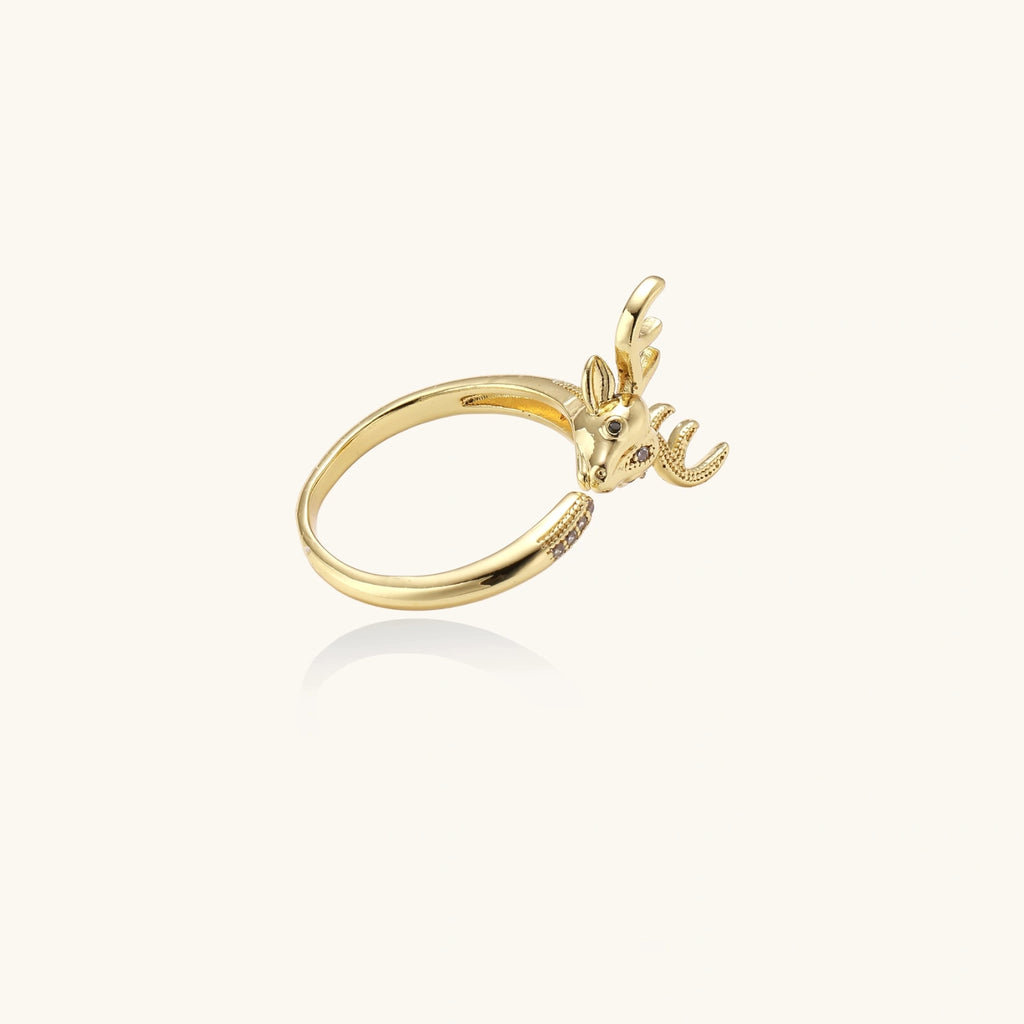 Gold-plated adjustable ring featuring 3D deer head with detailed antlers and cubic zirconia accents on cream background