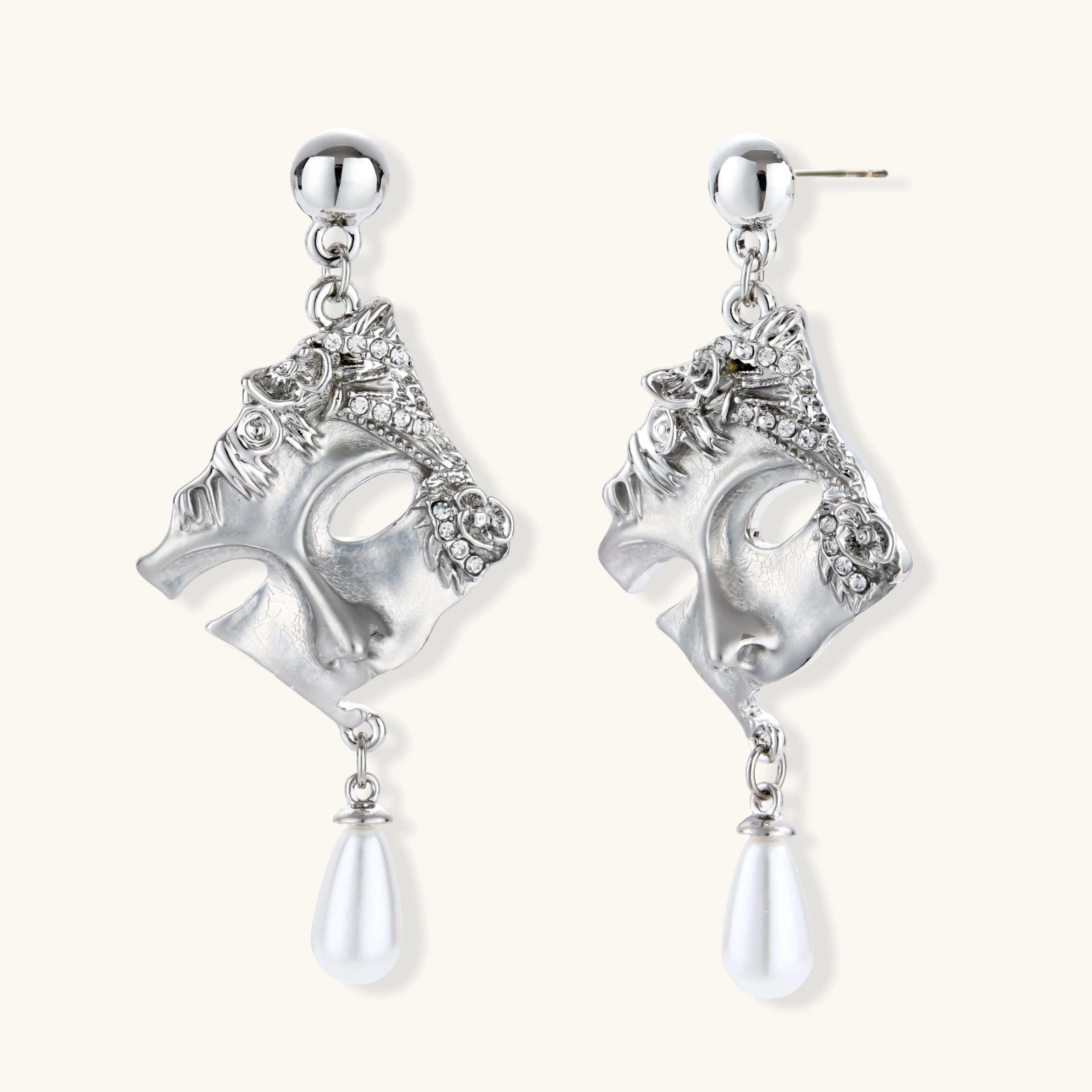 Ornate silver-toned masquerade mask jewelry set featuring rhinestone details and pearl drop earrings on white background.