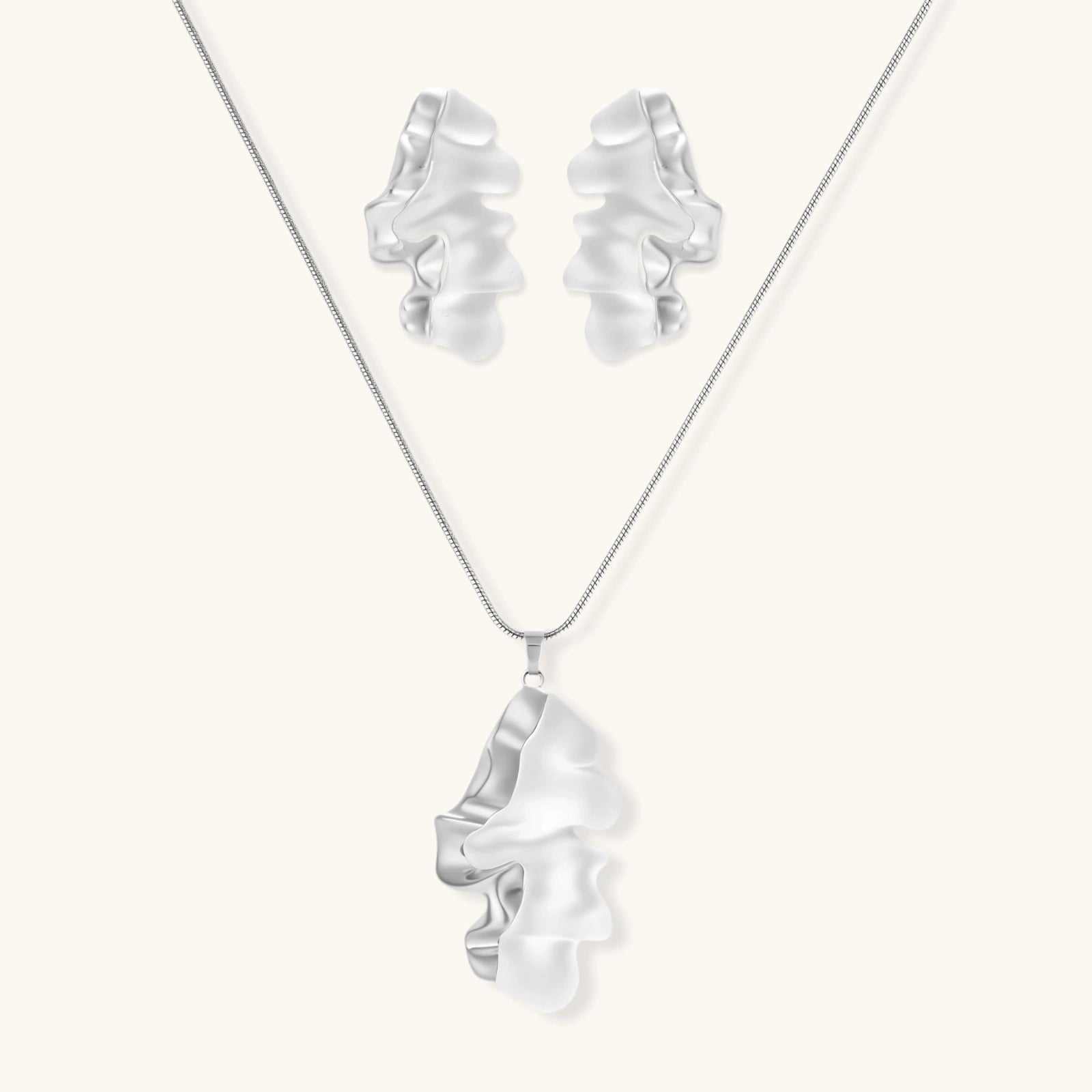 Modern sculptural jewelry set with flowing ribbon-like earrings and matching pendant in eco-zinc alloy finish