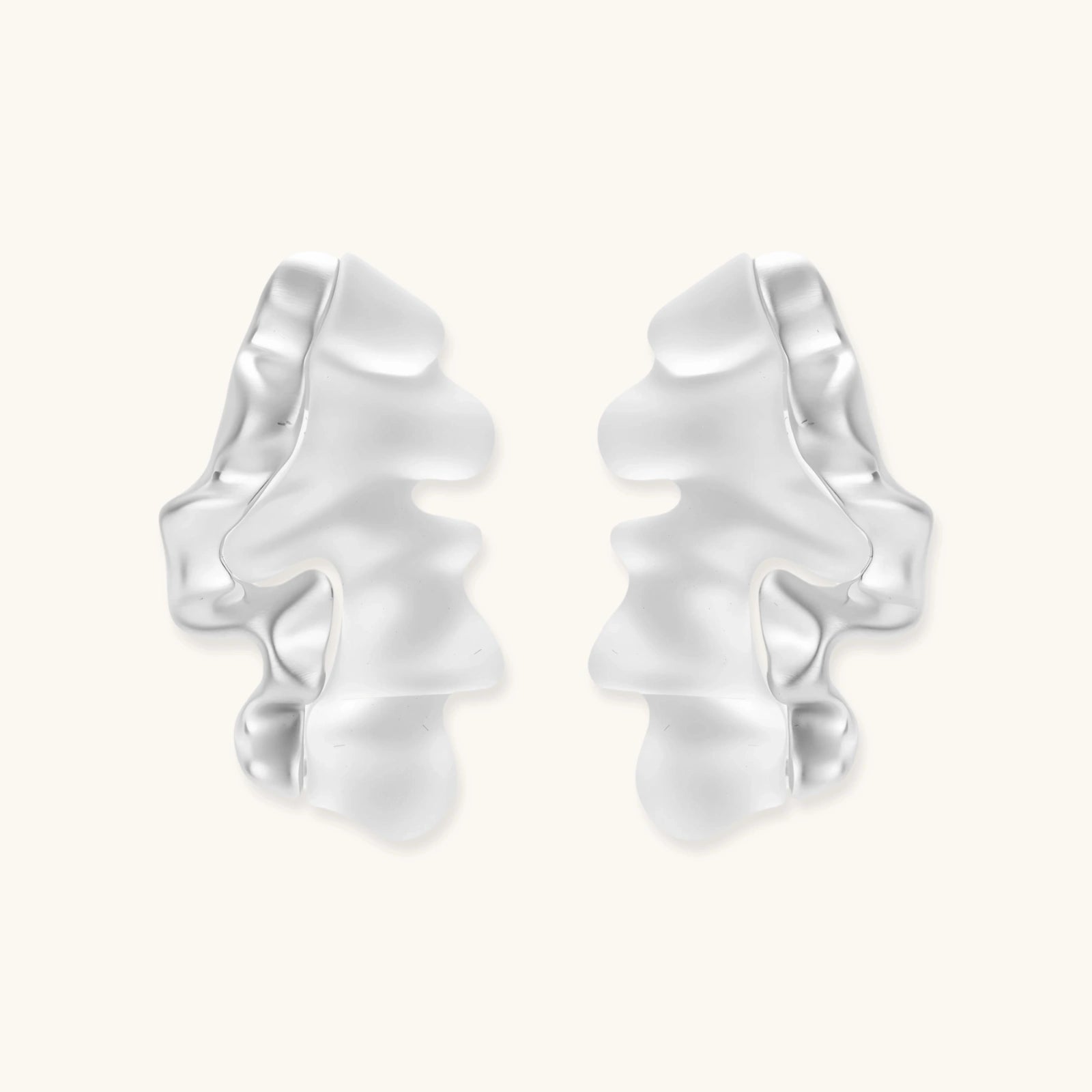 Modern sculptural jewelry set with flowing ribbon-like earrings and matching pendant in eco-zinc alloy finish