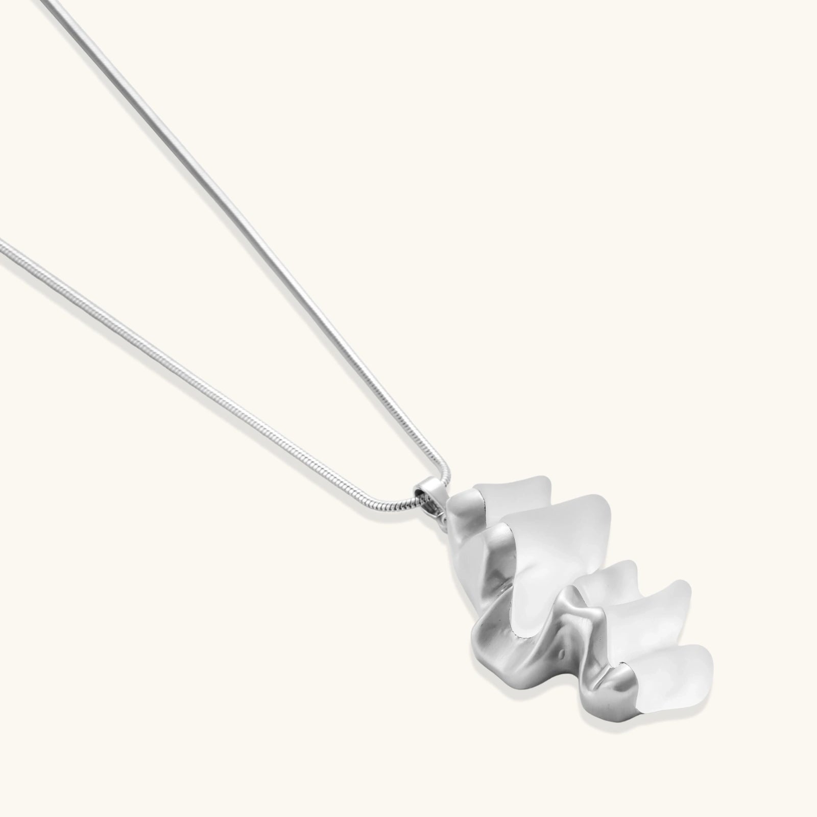 Modern sculptural jewelry set with flowing ribbon-like earrings and matching pendant in eco-zinc alloy finish