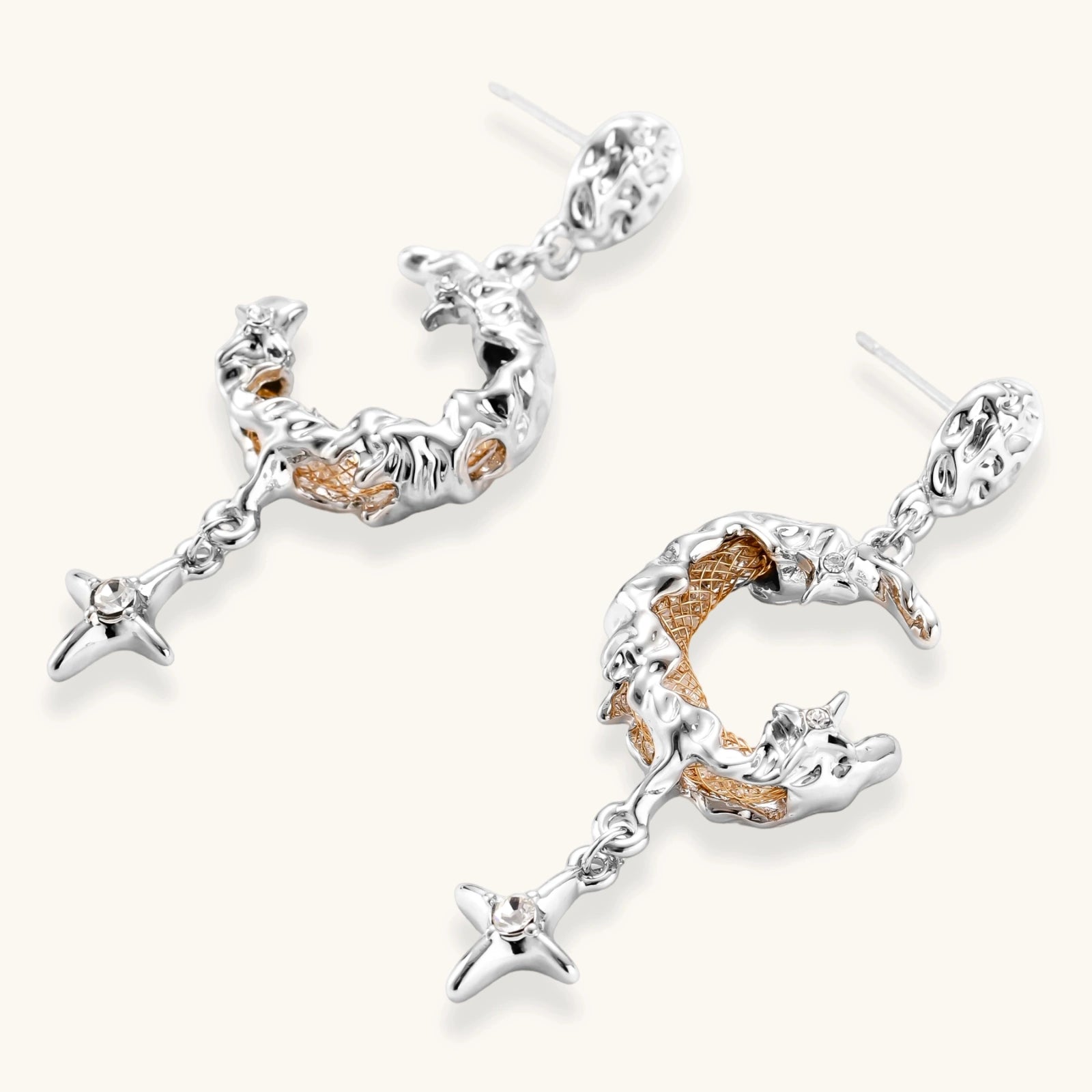 Mixed-metal jewelry set featuring layered necklaces with crescent moon pendant and pearl beads, plus matching star-drop earrings.