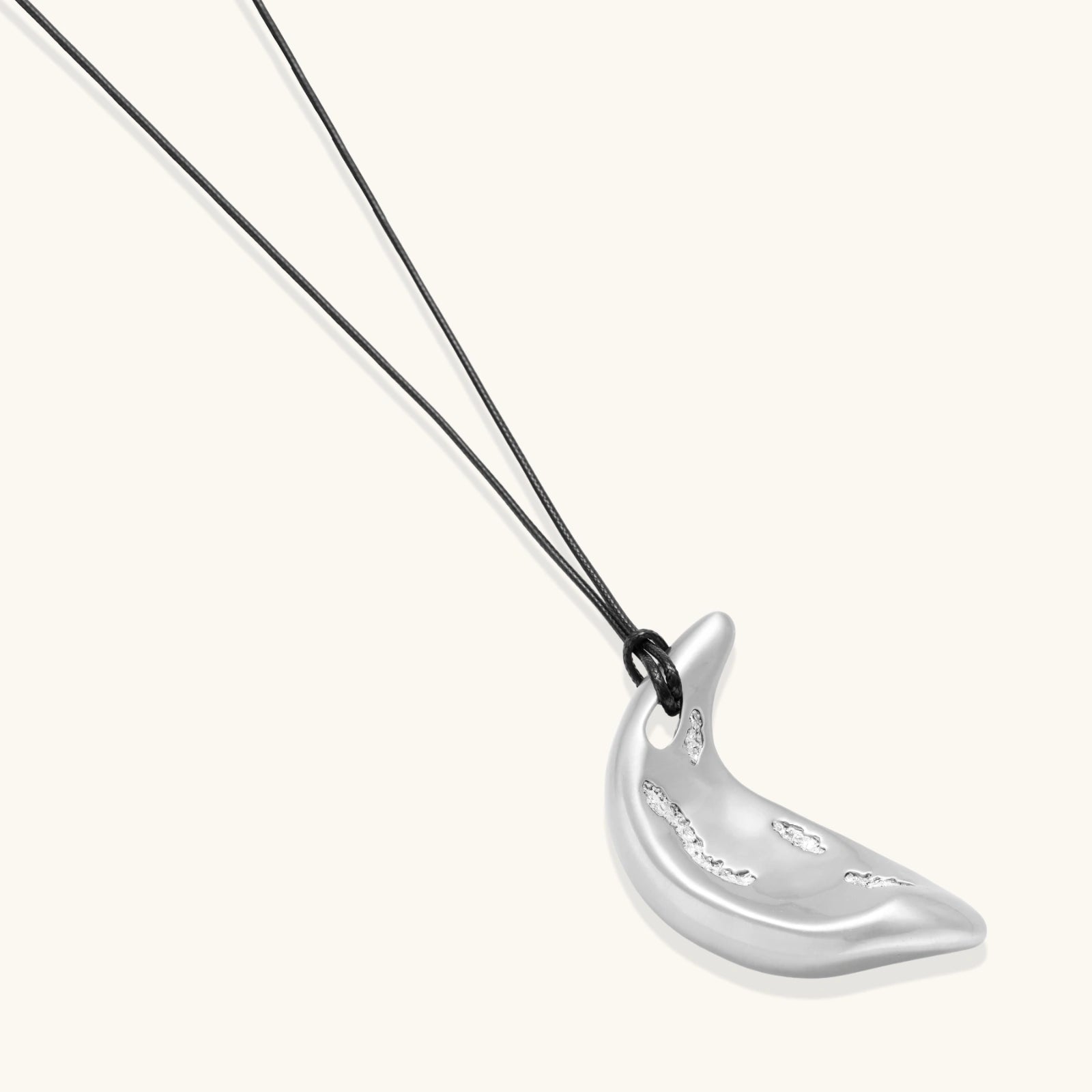 Adjustable crescent moon pendant necklace in gold and silver eco-zinc alloy with decorative engravings on black cord