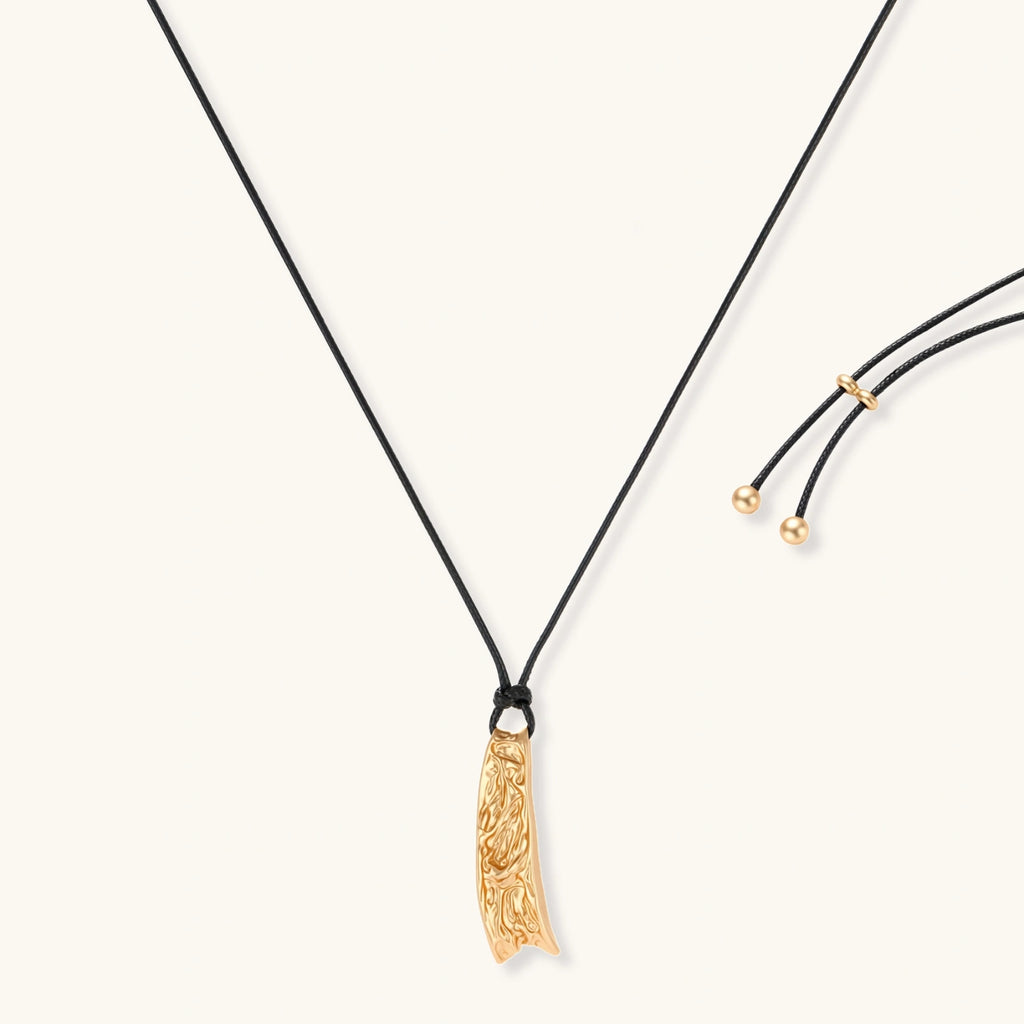 Curved textured pendant necklace on black adjustable cord with metallic finish in gold or silver