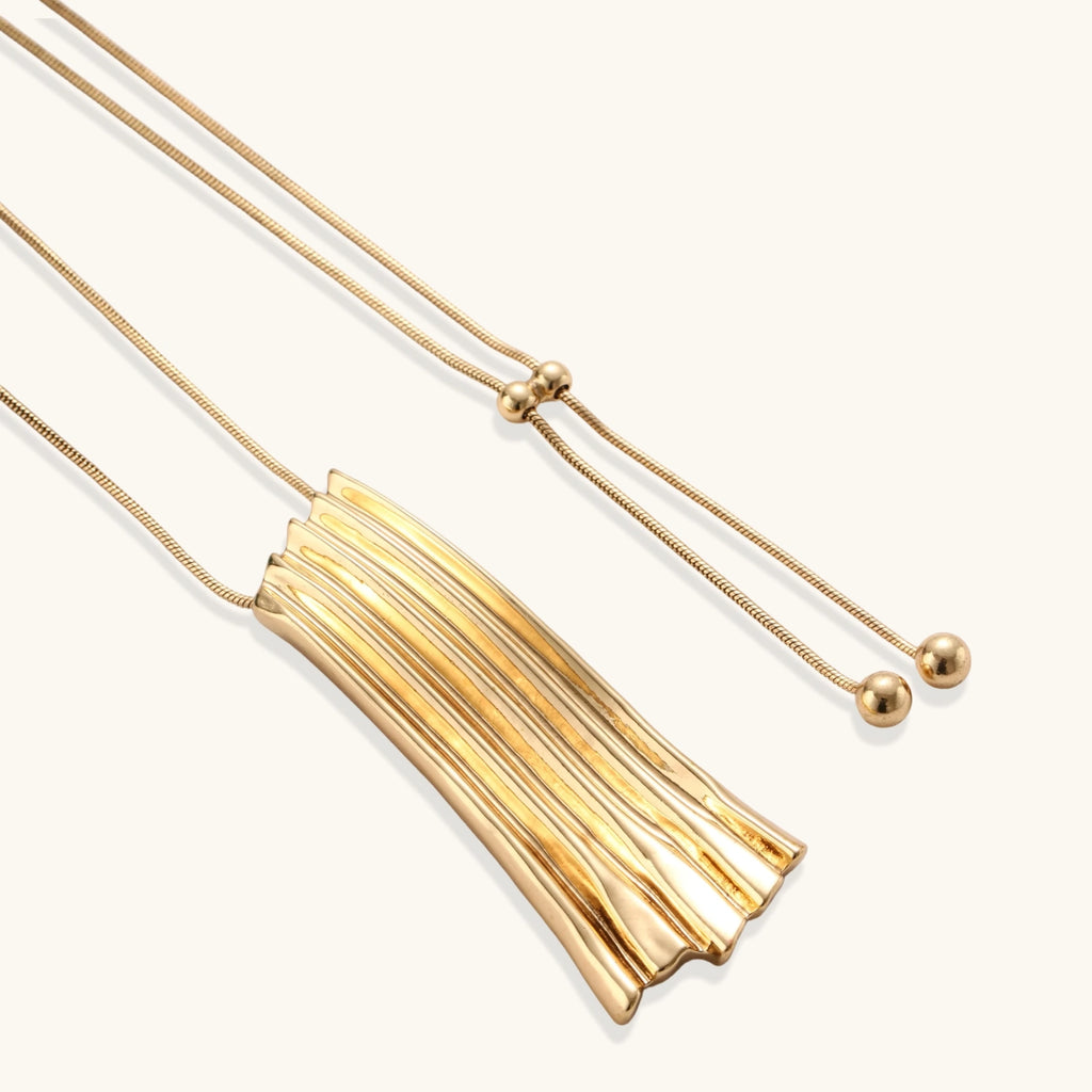 Modern adjustable necklace featuring geometric ribbed pendant with vertical lines in gold and silver finish options.