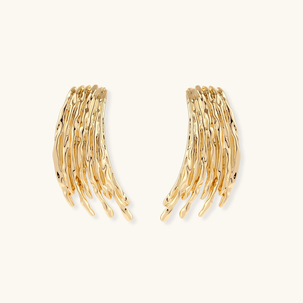 Flowing fringe earrings with cascading curved metal elements in gold tone, showing dimensional movement and sculptural design.