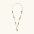 14K gold plated necklace with organic leaf motifs and freshwater pearls arranged in an elegant chain design on neutral background.