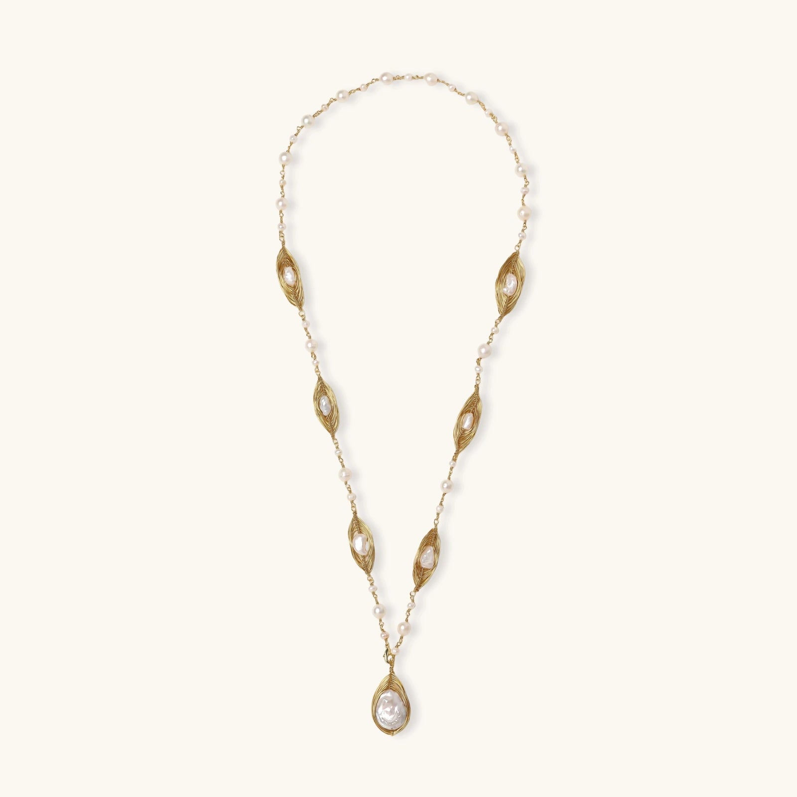 14K gold plated necklace with organic leaf motifs and freshwater pearls arranged in an elegant chain design on neutral background.