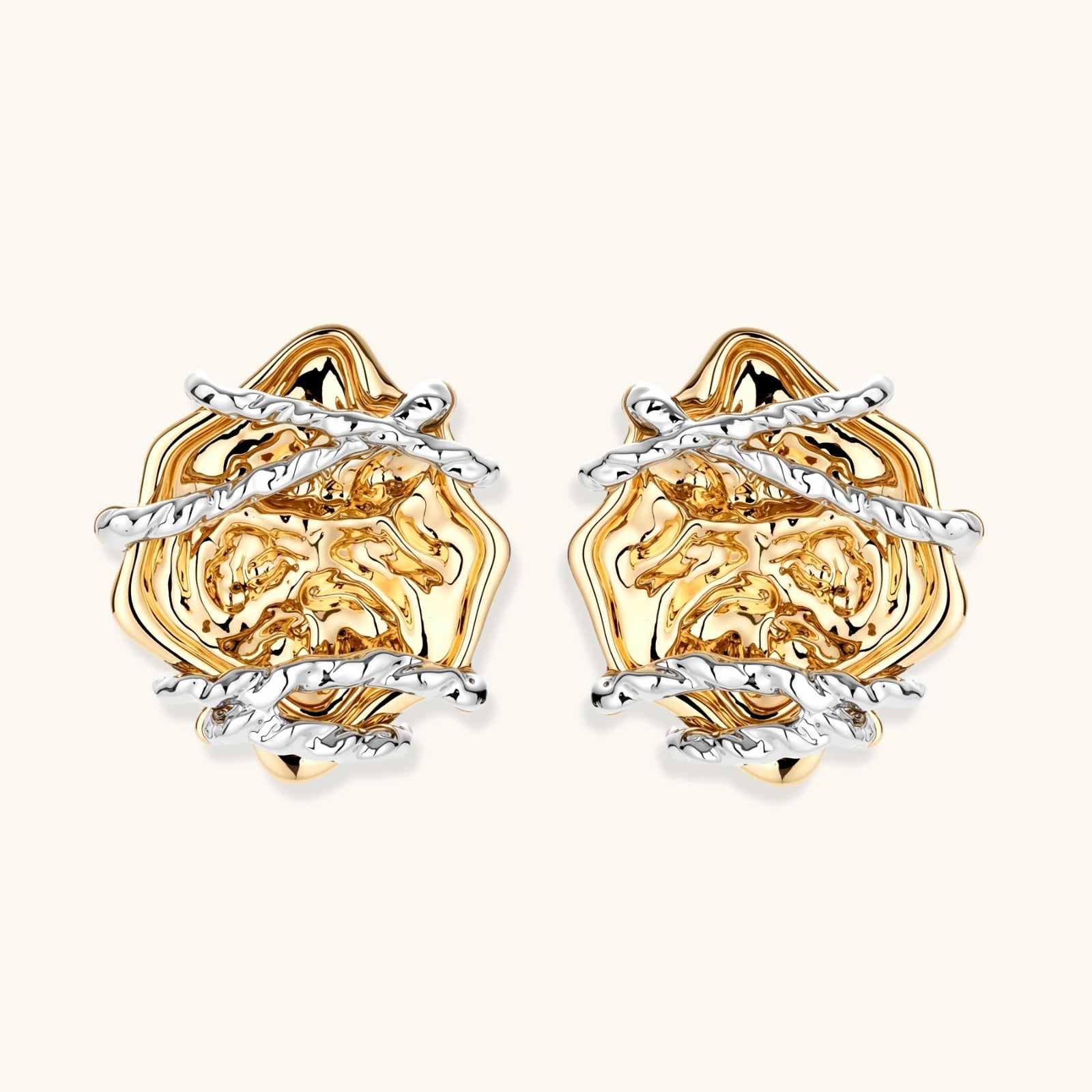 Sculptural rose-shaped stud earrings in gold with silver wire details and S925 posts on cream background.