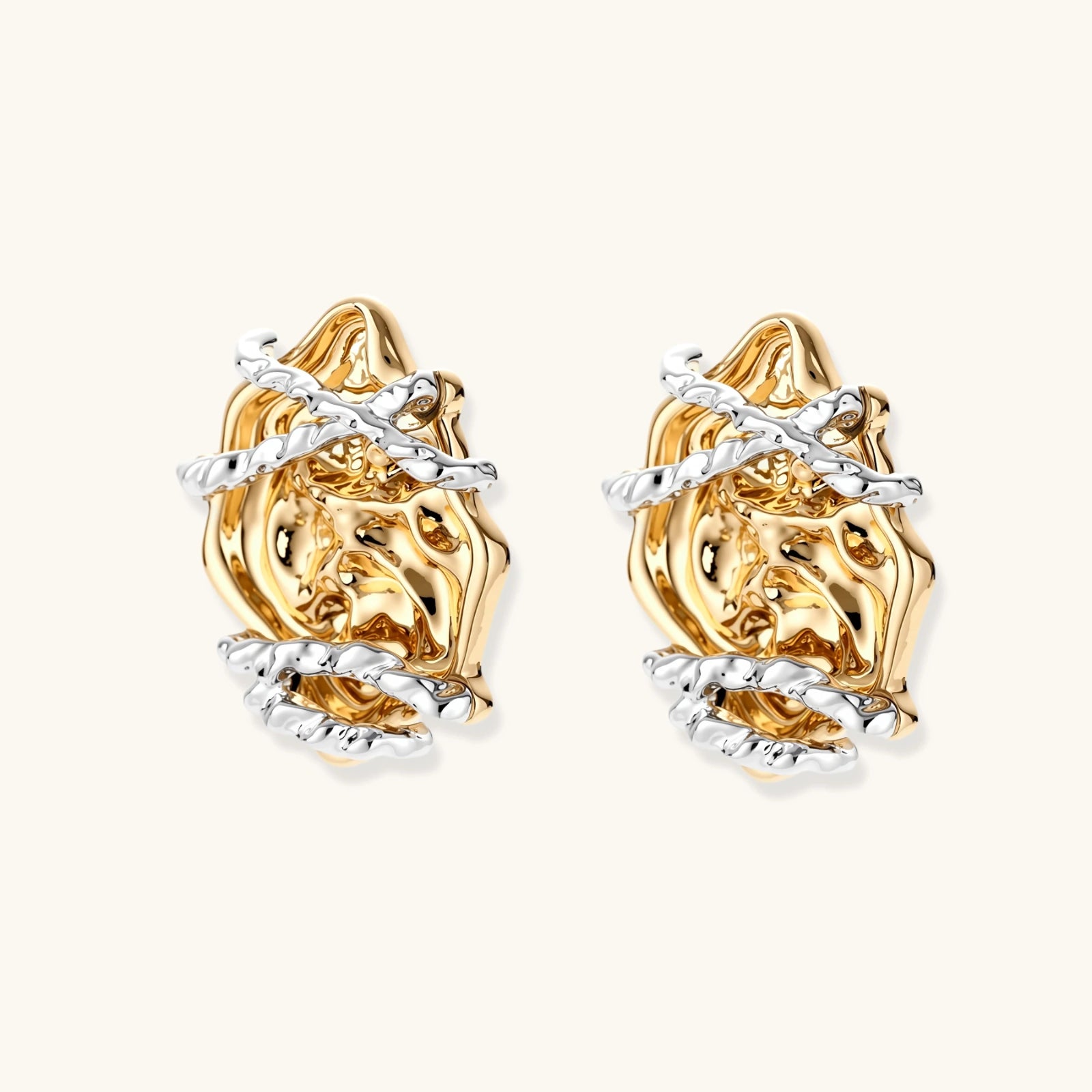 Sculptural rose-shaped stud earrings in gold with silver wire details and S925 posts on cream background.