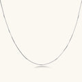 Delicate platinum-plated sterling silver necklace with alternating textured cubic links and smooth chain sections.