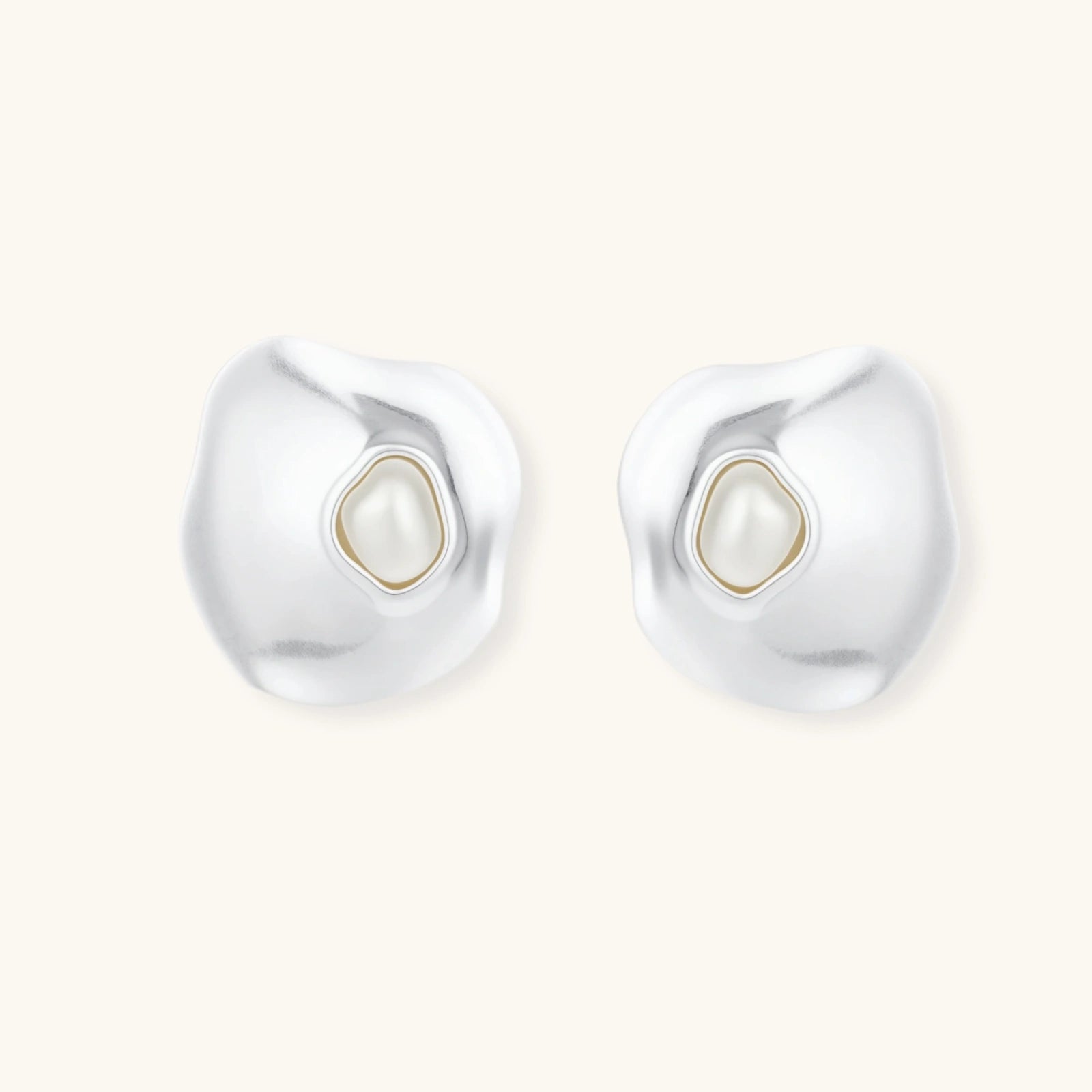 Organic silver stud earrings with white resin pearl centers in fluid stone-like shapes on light background.