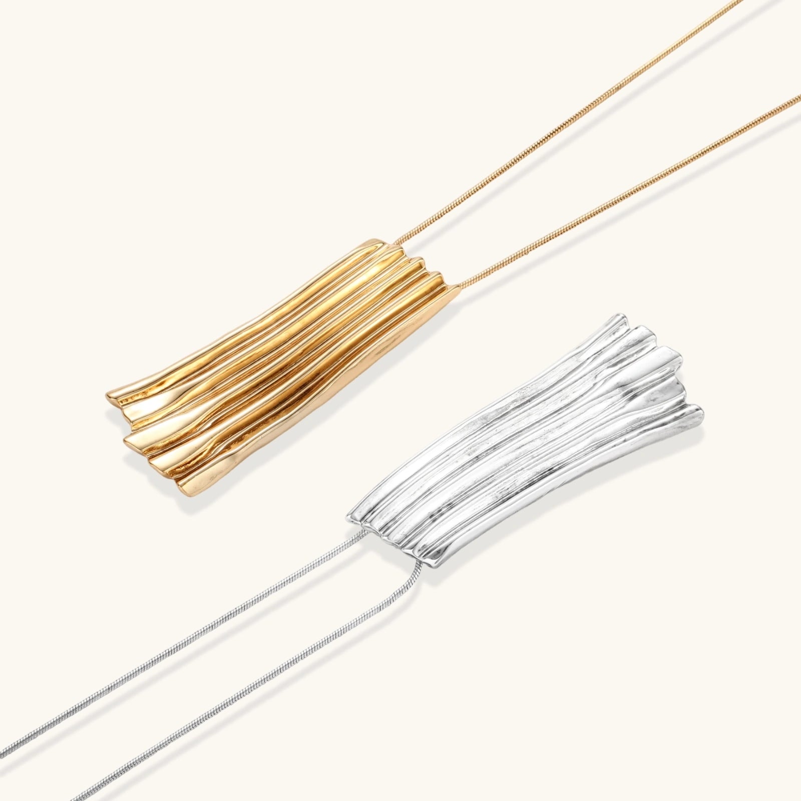 Modern silver necklace with vertical ridged pendant and adjustable chain on white background, eco-friendly zinc alloy construction.