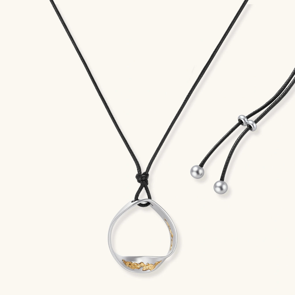 Minimalist silver and gold circle pendant on black adjustable cord, featuring eco-friendly zinc alloy construction