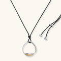 Minimalist silver and gold circle pendant on black adjustable cord, featuring eco-friendly zinc alloy construction