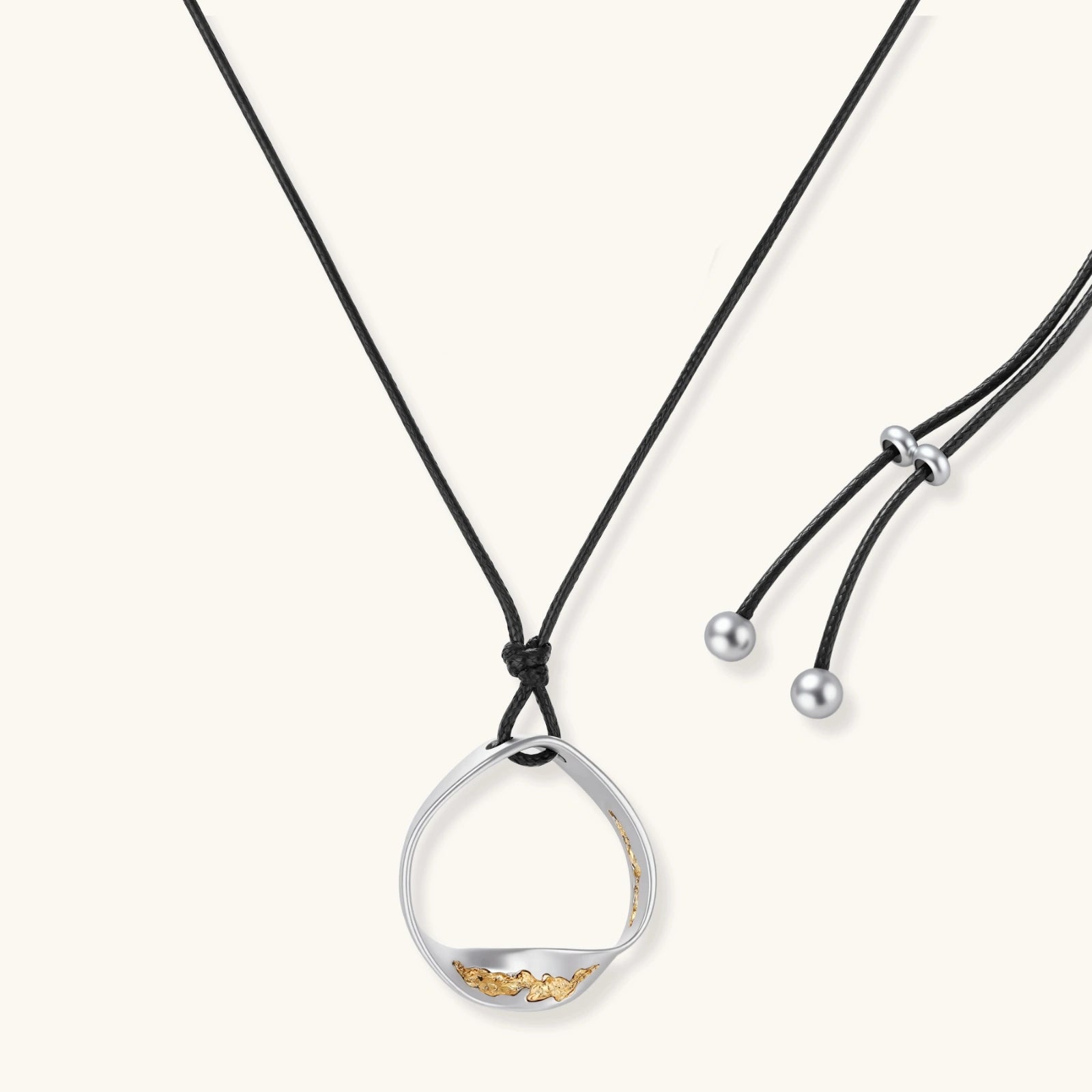 Minimalist silver and gold circle pendant on black adjustable cord, featuring eco-friendly zinc alloy construction