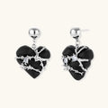 Black heart-shaped wood earrings with decorative silver chains and crystal accents hanging from silver ball studs