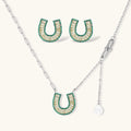 Geometric horseshoe-shaped jewelry set with radiating white zirconia center and jade-green border stones on white background.