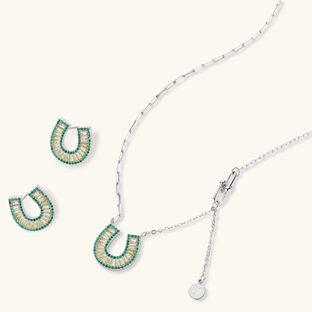 Geometric horseshoe-shaped jewelry set with radiating white zirconia center and jade-green border stones on white background.