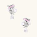 Dainty white gold plated starfish earrings with pink enamel, white pearls, and teardrop crystals on light background.