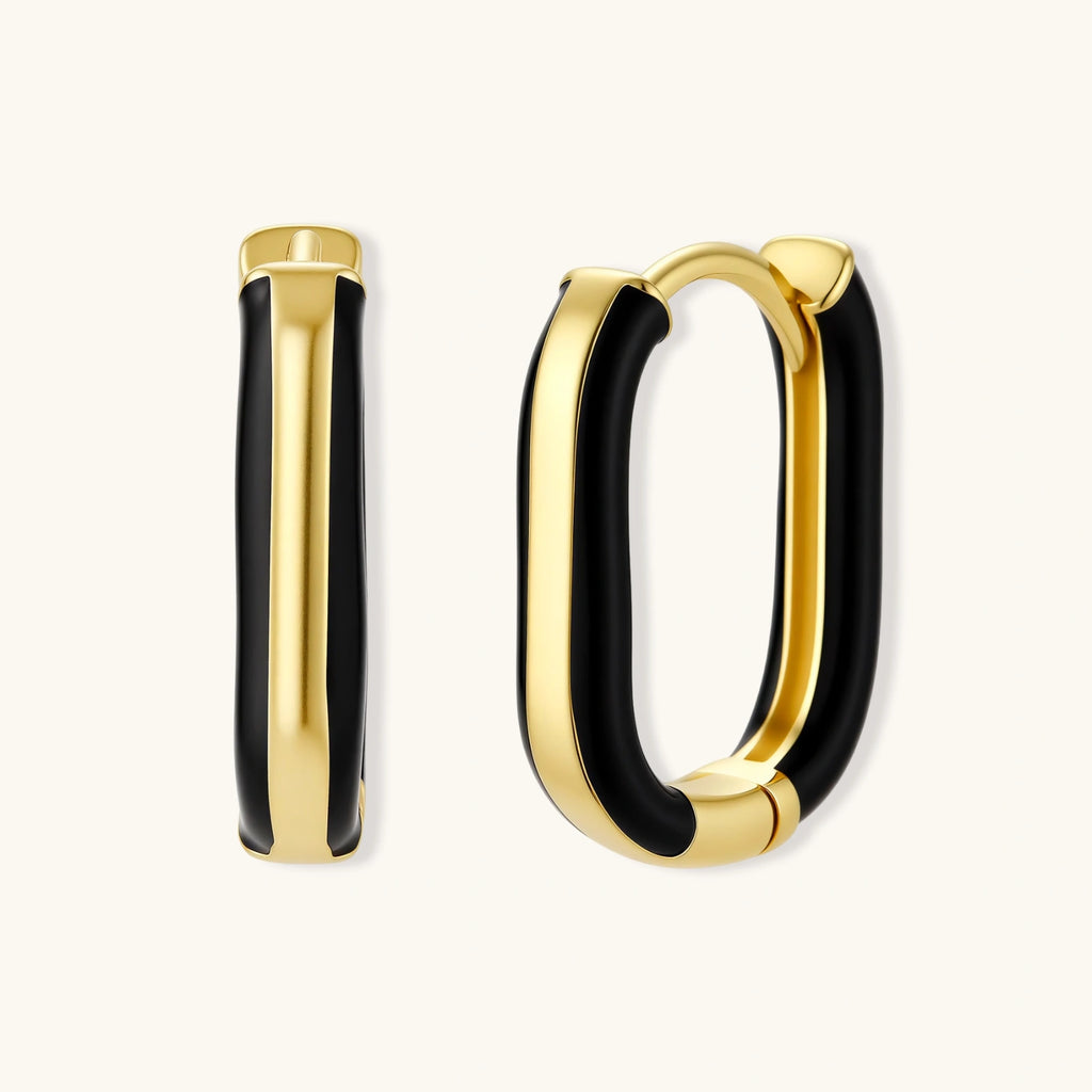Modern hoop earrings with gold-plated and black sections, featuring hinged closure on white background.