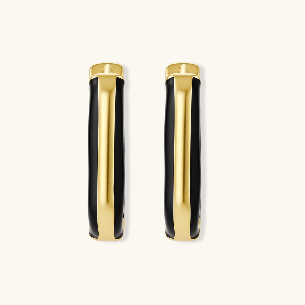 Modern hoop earrings with gold-plated and black sections, featuring hinged closure on white background.