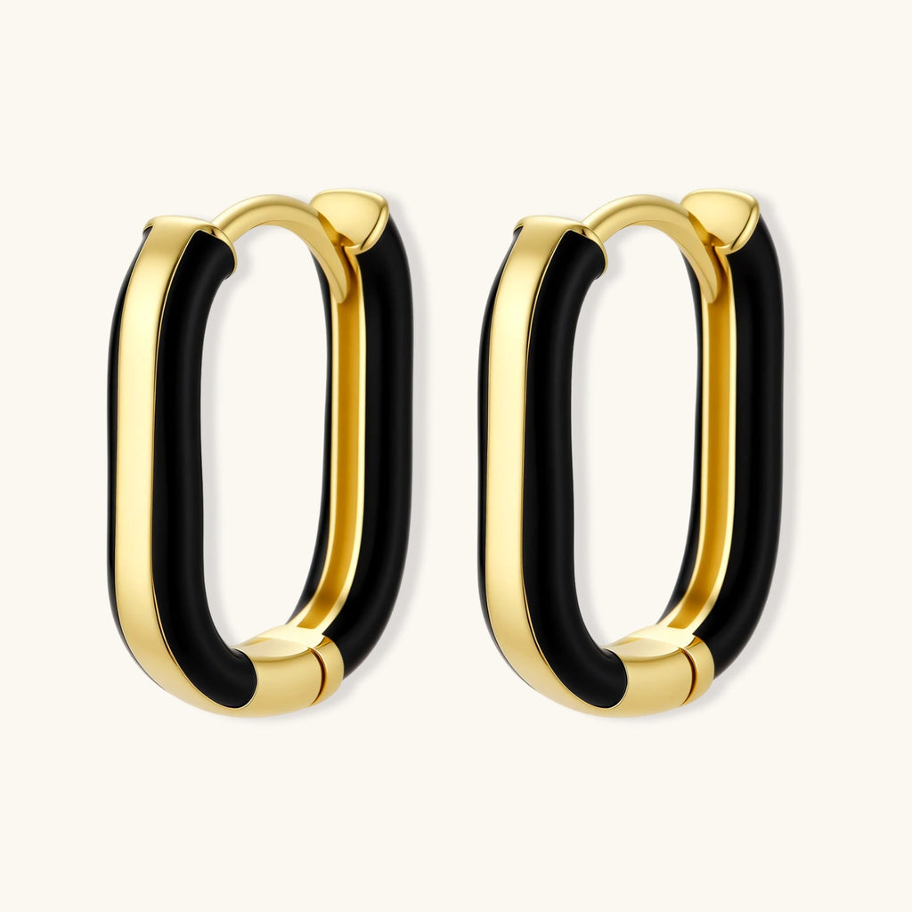 Modern hoop earrings with gold-plated and black sections, featuring hinged closure on white background.