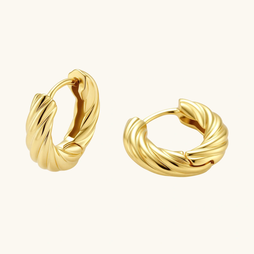 14K gold-plated twisted rope huggie hoop earrings with hinged closure on white background, showing textured surface detail