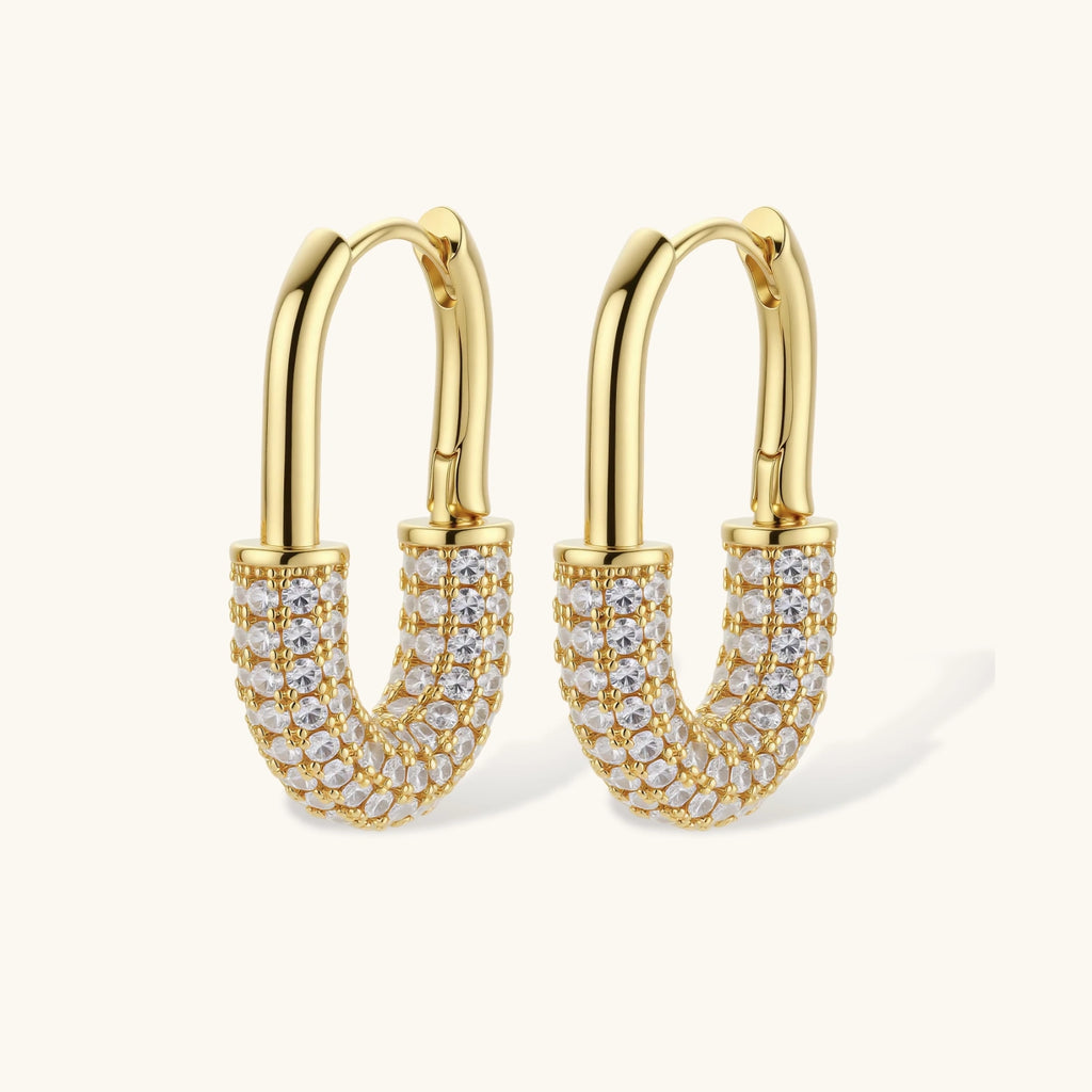 Gold-plated huggie hoop earrings with pavé zirconia stones covering the bottom curve, shown in open and closed positions.
