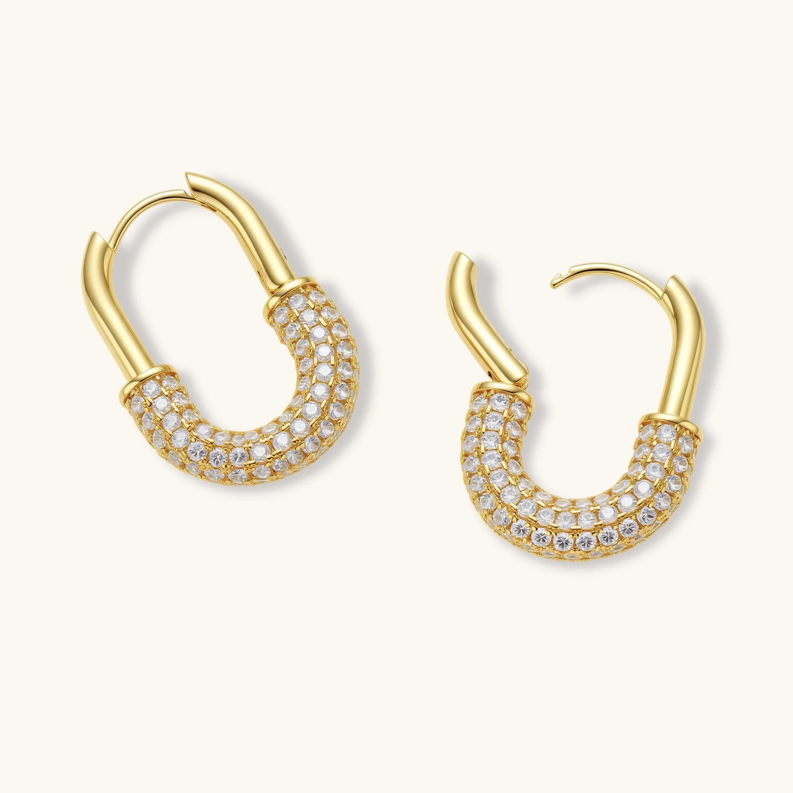 Gold-plated huggie hoop earrings with pavé zirconia stones covering the bottom curve, shown in open and closed positions.