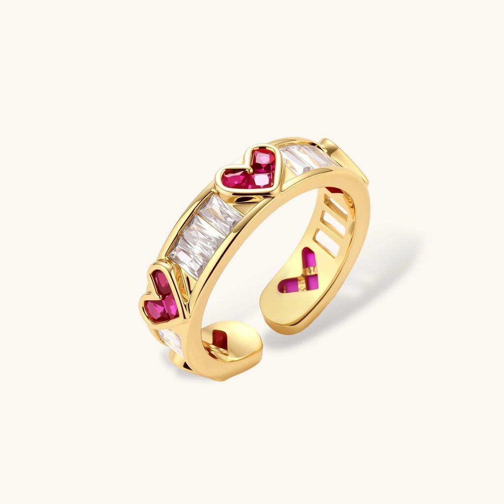 Gold-plated adjustable ring with alternating red heart-shaped and clear rectangular zirconia stones in geometric pattern
