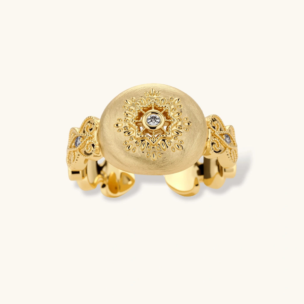 Ornate gold-plated ring with detailed engravings and central zirconia stone on adjustable band