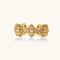 Gold-plated adjustable ring with multiple flower motifs, each featuring a central pearl and cubic zirconia stones