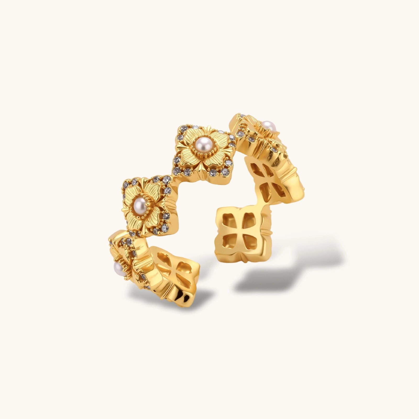 Gold-plated adjustable ring with multiple flower motifs, each featuring a central pearl and cubic zirconia stones