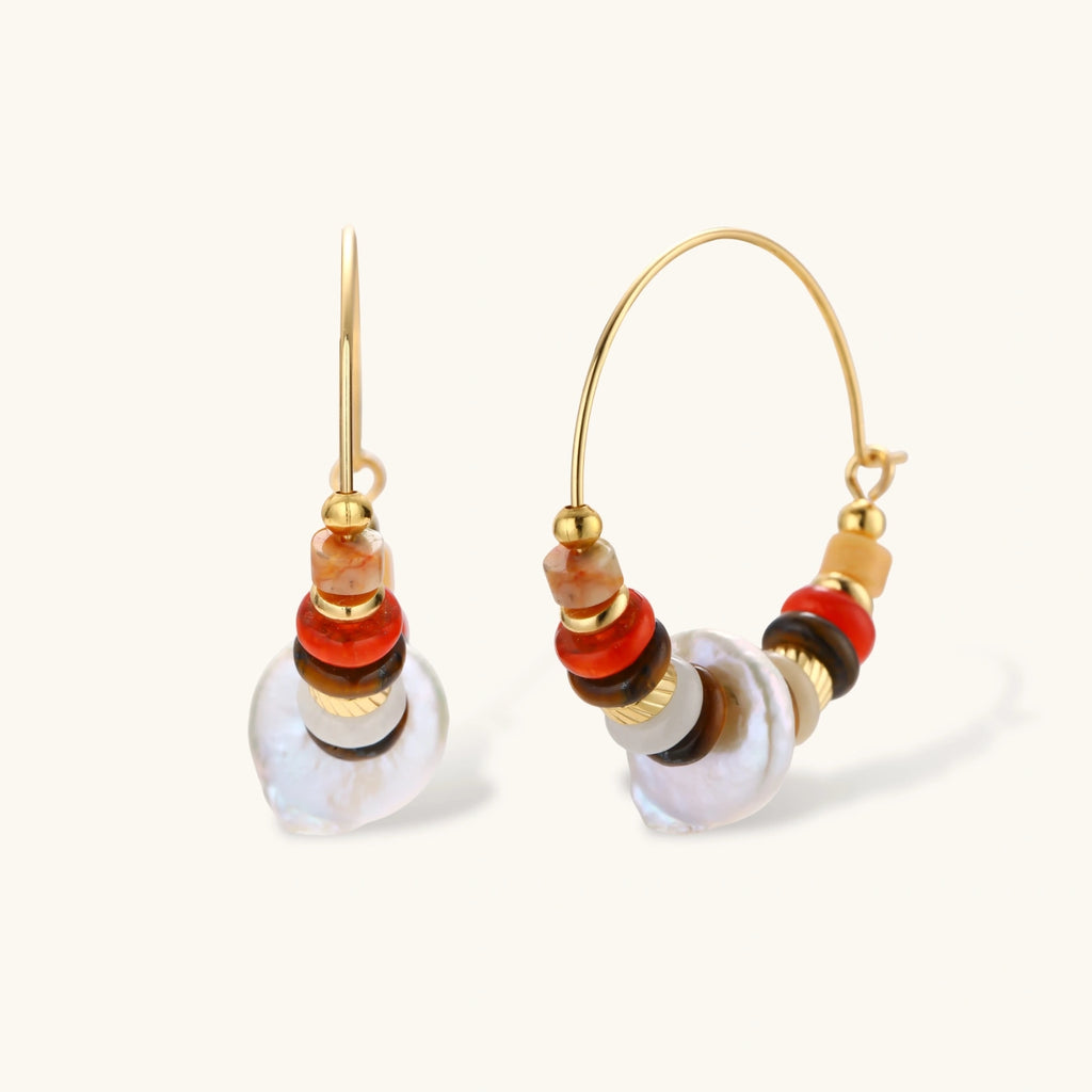 18k gold-plated earrings featuring baroque pearls and colorful natural stones in a stacked design on cream background.