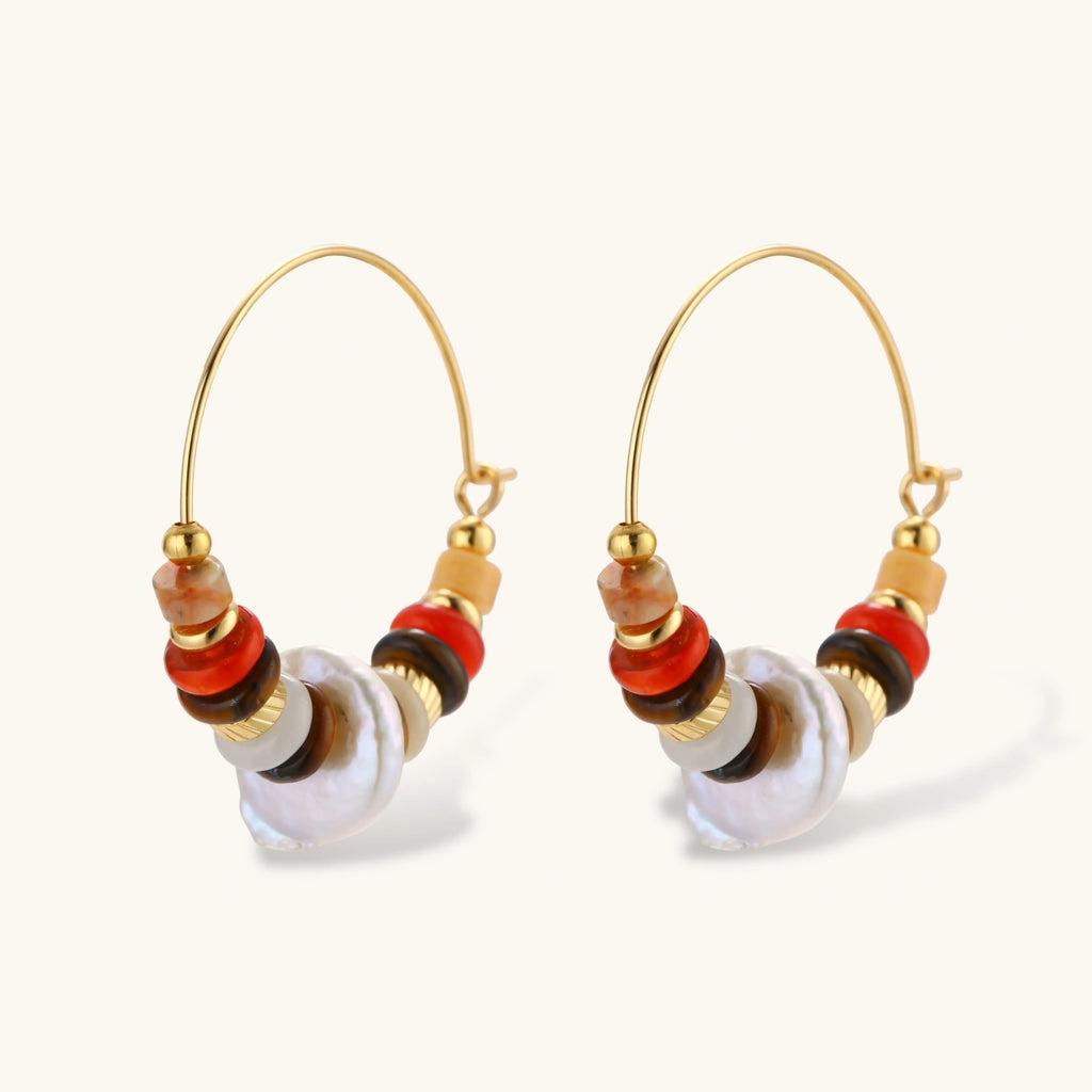 18k gold-plated earrings featuring baroque pearls and colorful natural stones in a stacked design on cream background.