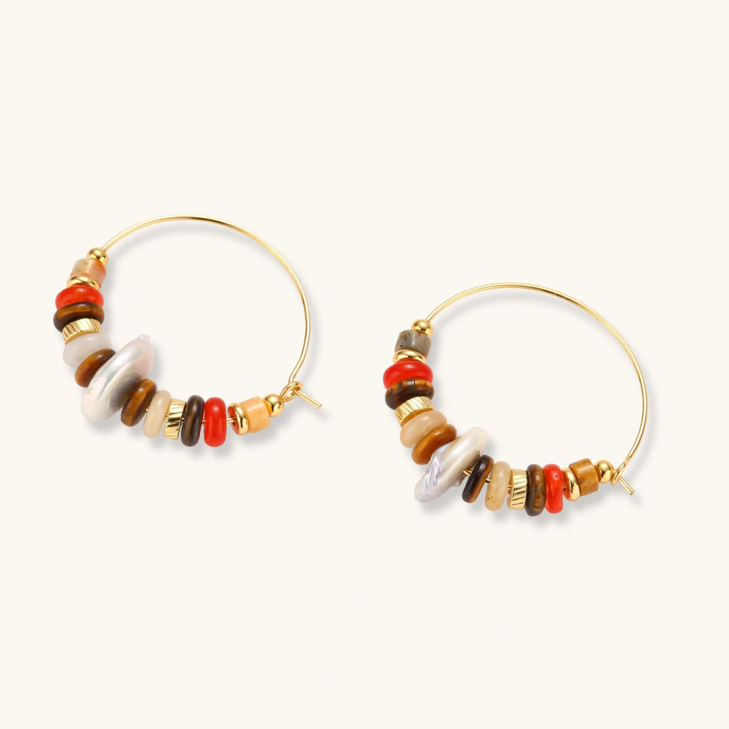 18k gold-plated earrings featuring baroque pearls and colorful natural stones in a stacked design on cream background.