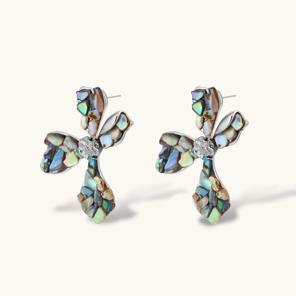 Cross-shaped stud earrings with iridescent abalone shell mosaic in blues and greens, silver-plated setting with crystal center